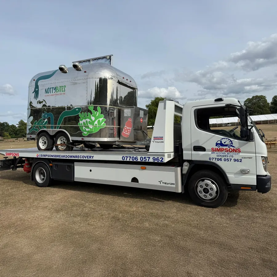Catering trailer loaded on a Simpsons Breakdown Recovery flatbed at a showground