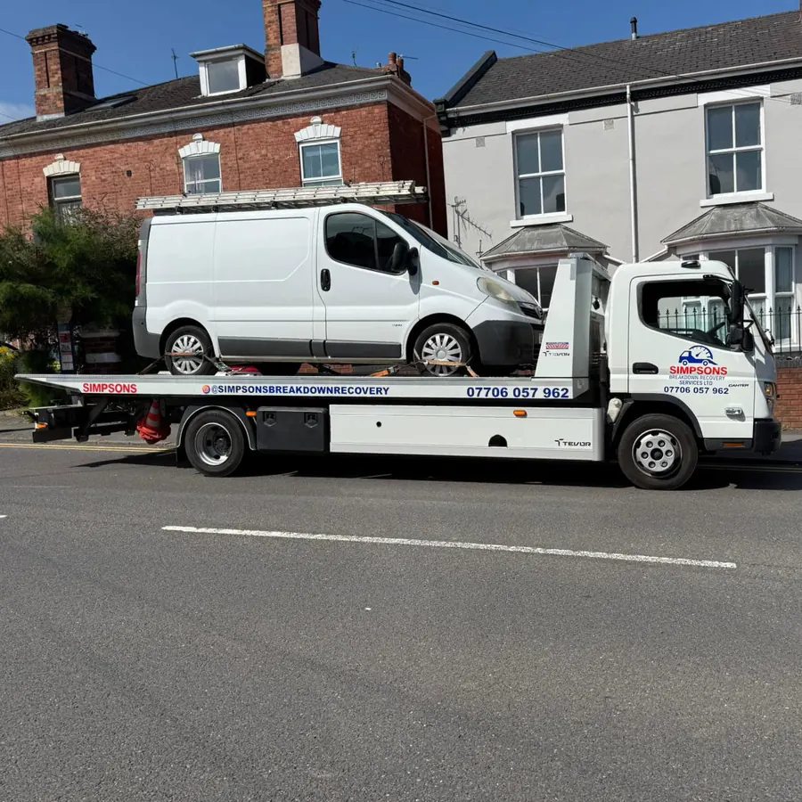 Simpsons Breakdown Recovery flatbed loading a white Renault Trafic work van in Birmingham